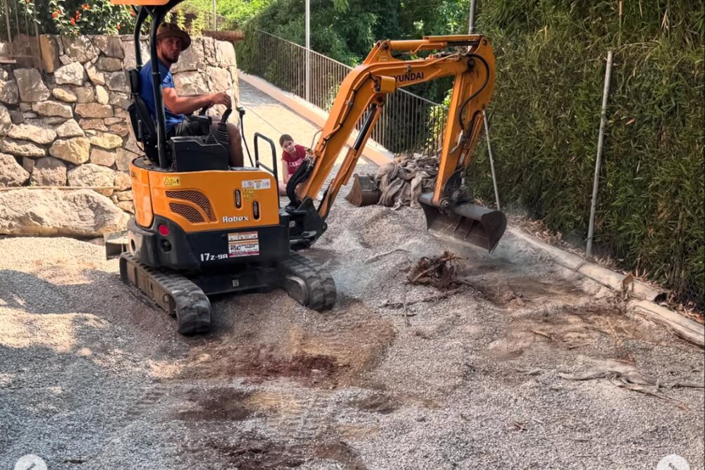 Jardinier professionnel poussant une brouette dans un jardin en entretien